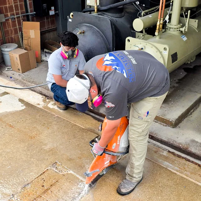 Mountain West crew using a concrete saw at a commercial job site in Utah.