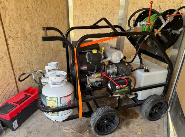 Mountain West hydro jetting rig with its motor, water tank, and hose reel in Utah.