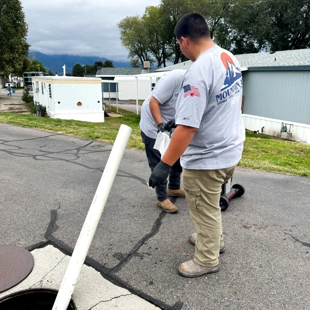 Mountain West crew working at an open sewer access point in Utah.